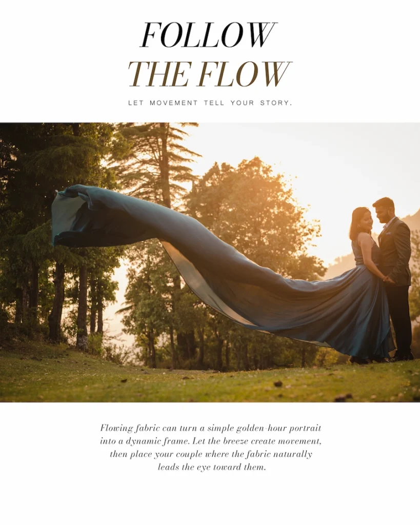 Couple standing in a pine forest at sunset with a long blue gown flowing in the wind across the frame