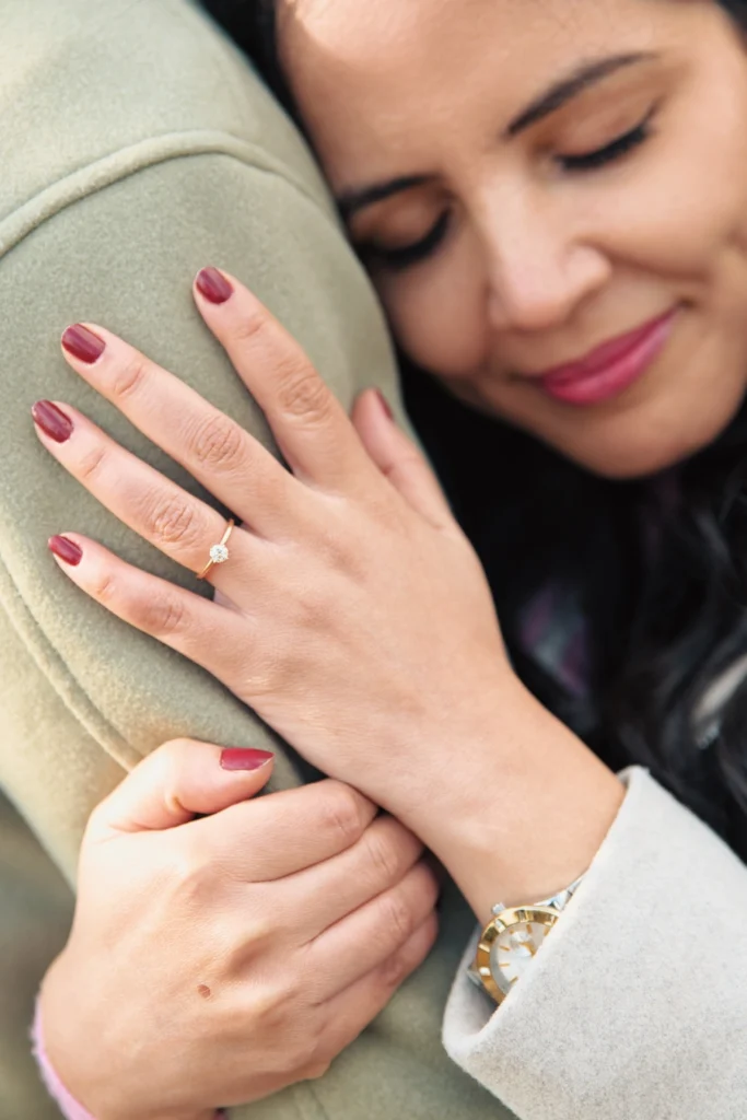 Close-up of a couple holding hands affectionately.