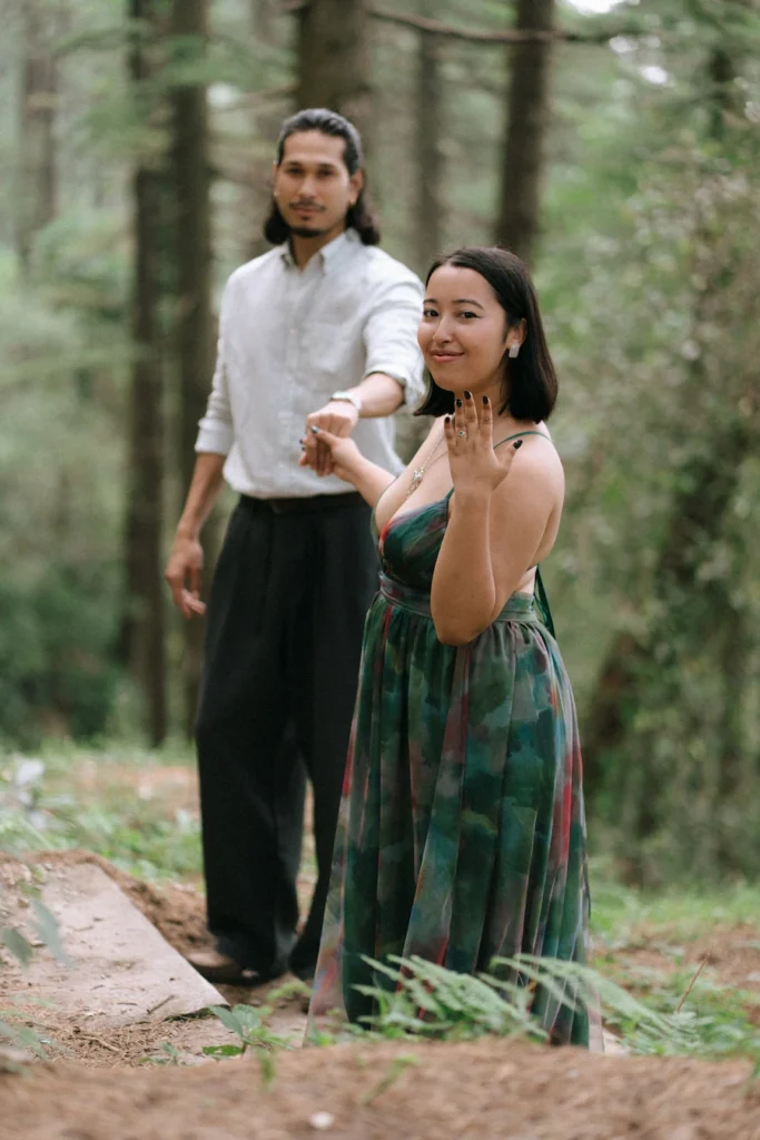 A couple walking together through the forest, sharing a quiet moment