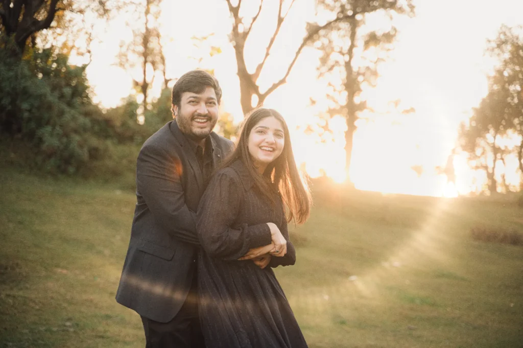 Golden hour couple photography in Mussoorie with a couple embracing in warm sunset light among trees