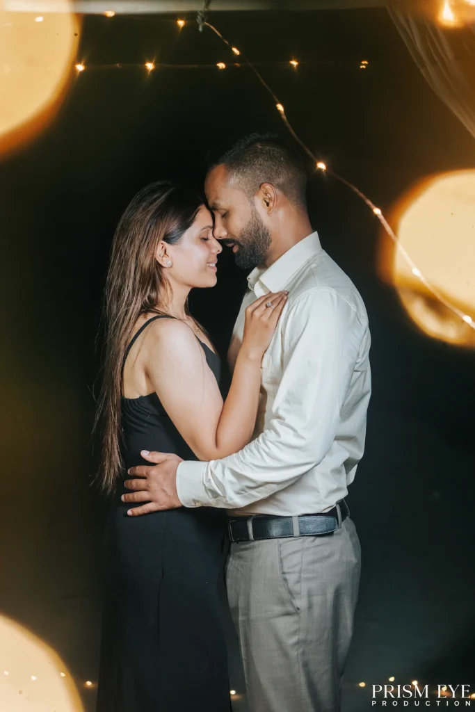Couple sharing an intimate embrace during a romantic proposal photoshoot, surrounded by warm golden lights in Rishikesh.