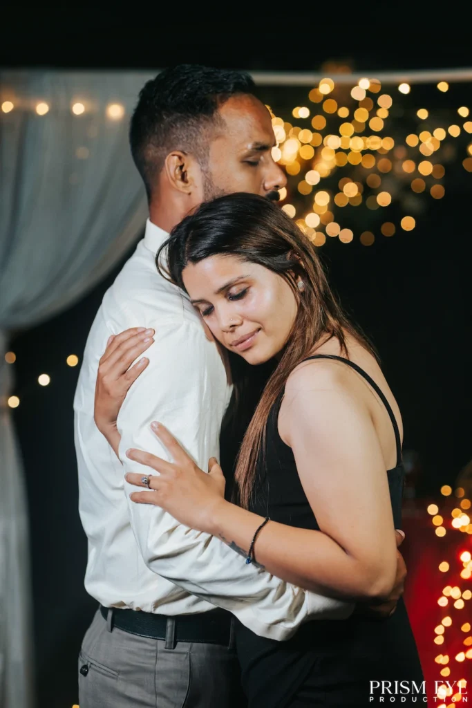 Couple sharing a tender embrace during an intimate proposal photoshoot, surrounded by warm fairy lights in Rishikesh