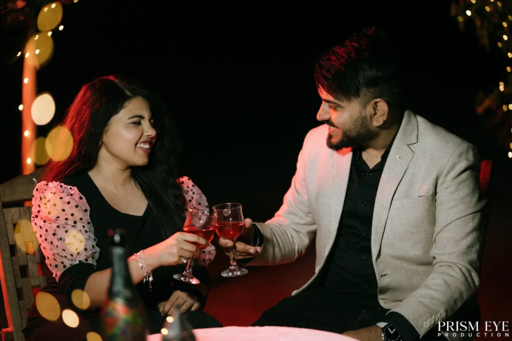 Couple sharing a romantic toast during a candlelit proposal shoot in Rishikesh.