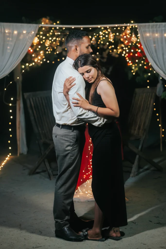 Couple sharing a warm embrace during a romantic evening photoshoot near Ram Jhula, Rishikesh.