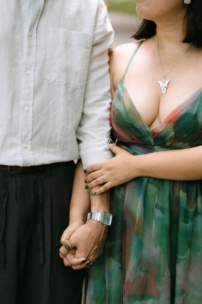 A couple holding hands closely during a quiet romantic moment