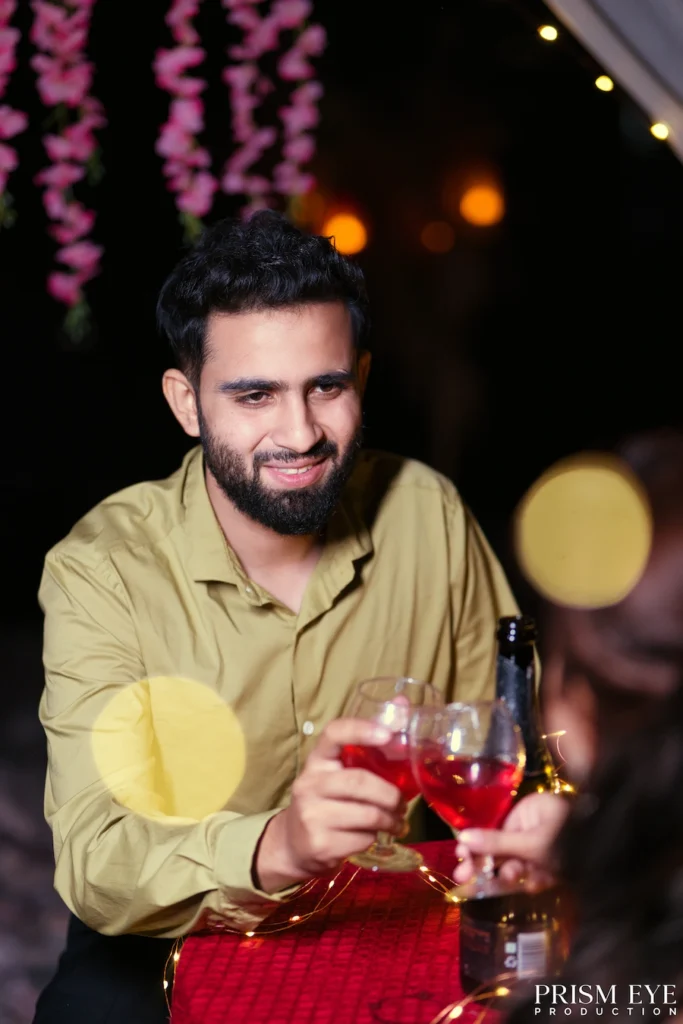 Groom-to-be raising a glass during a romantic proposal celebration in Rishikesh.