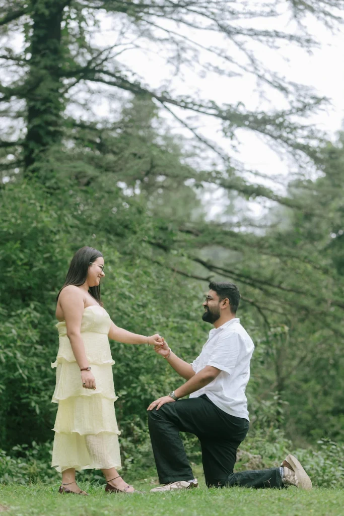 Man proposing to his partner outdoors.
