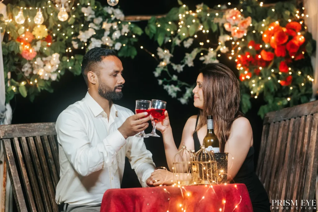 Couple sharing a romantic toast during a proposal shoot in Rishikesh.