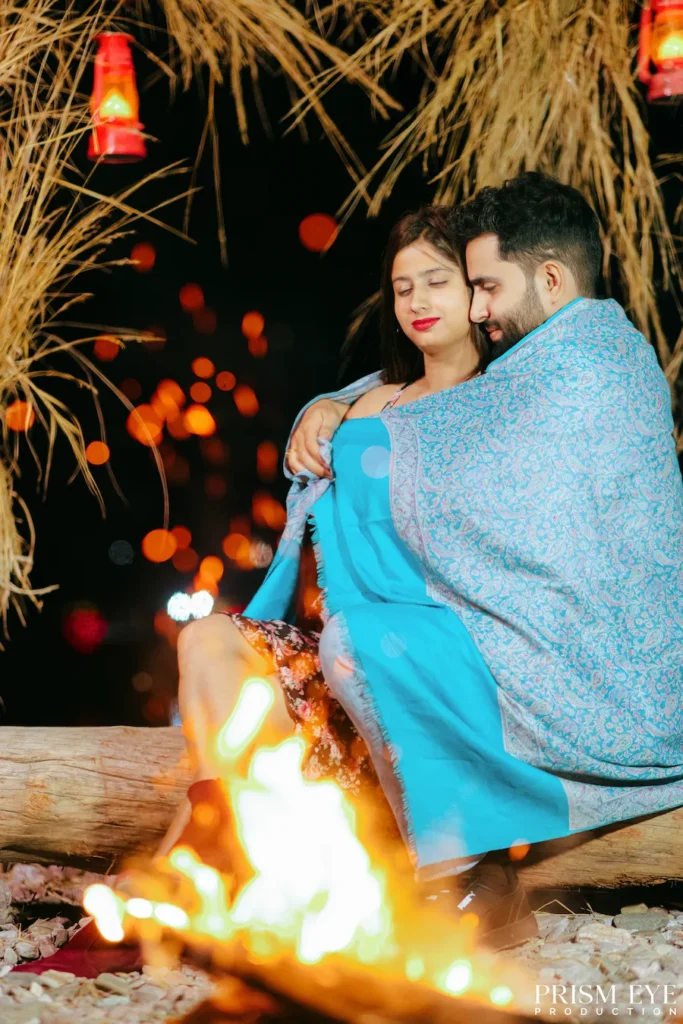 Couple cuddling by a bonfire during a Rishikesh proposal shoot