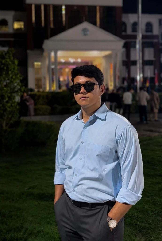 Professional portrait of a photographer wearing sunglasses and a light blue shirt outdoors