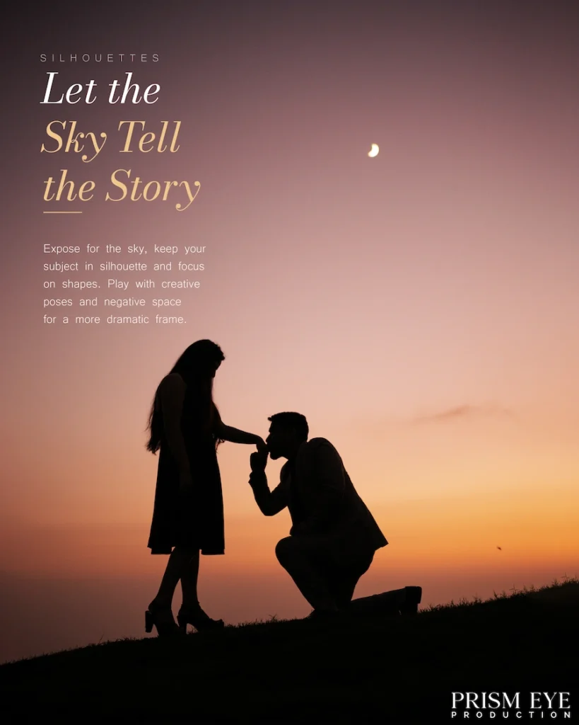 Sunset silhouette photo of a couple, man kneeling and kissing woman's hand under a pink and orange sky