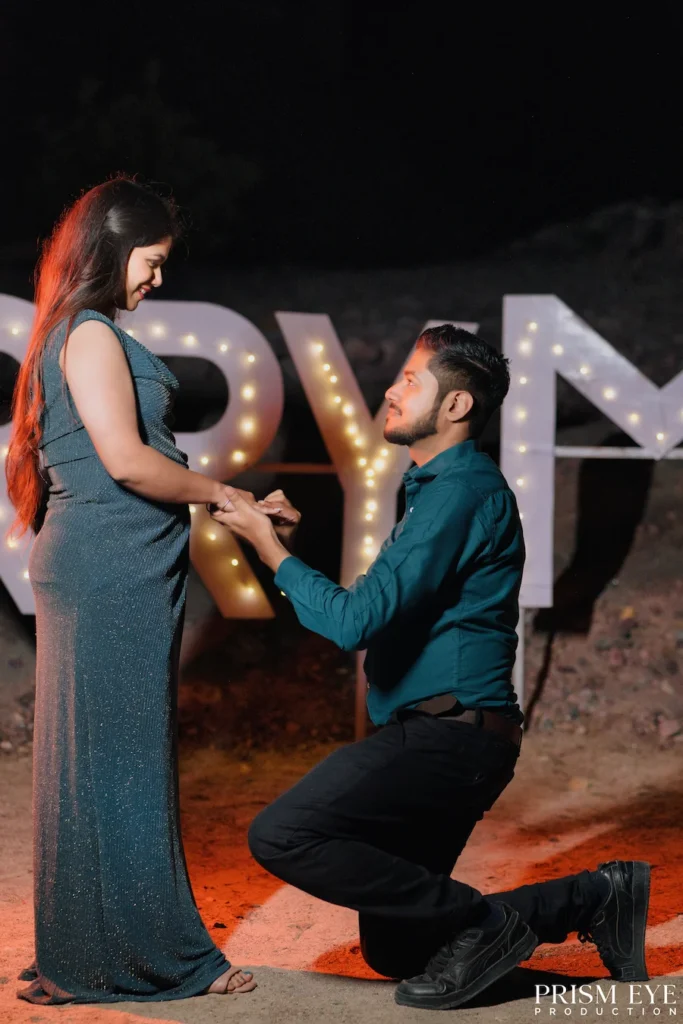 Couple sharing a romantic proposal moment on Ganga beach in Rishikesh