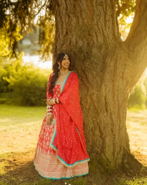 Sunlit Bridal Portrait in Red Lehenga Under Tree | Uttarakhand Wedding Photographer