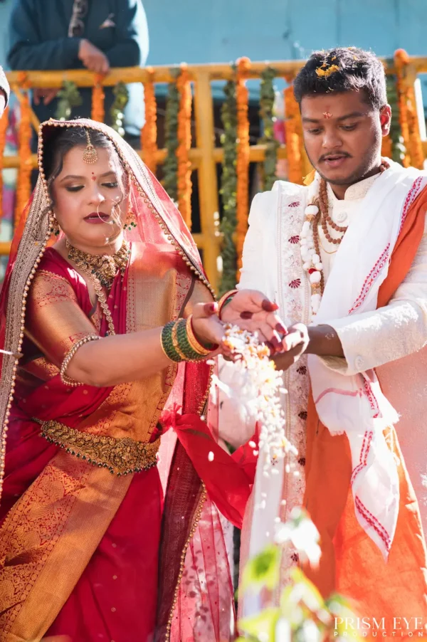 Bride and groom performing a traditional wedding ritual together in their wedding ceremony.