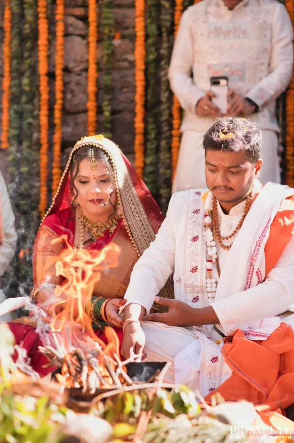 Bride and groom seated beside the sacred fire during their Triyuginarayan wedding ceremony.