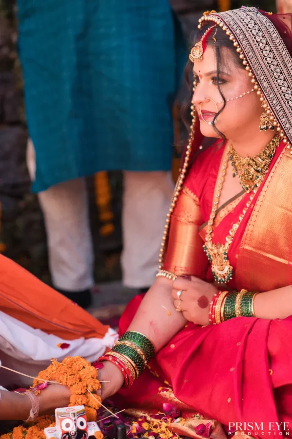 Bride smiling during a traditional wedding ritual at Triyuginarayan Temple.