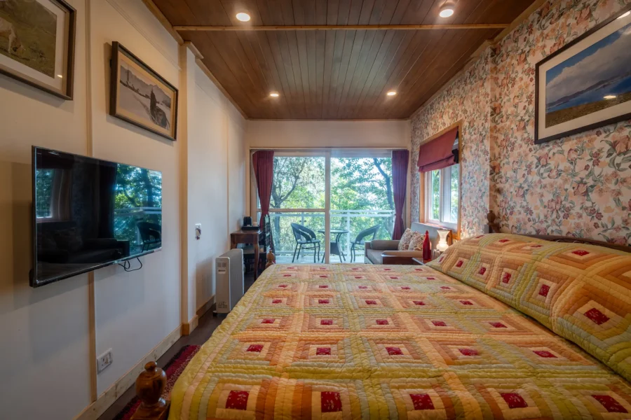 Elegant mountain view bedroom in Landour, Mussoorie featuring a private balcony, cozy interiors, and peaceful forest surroundings. Spacious mountain view bedroom with balcony in Landour, Mussoorie, Uttarakhand.