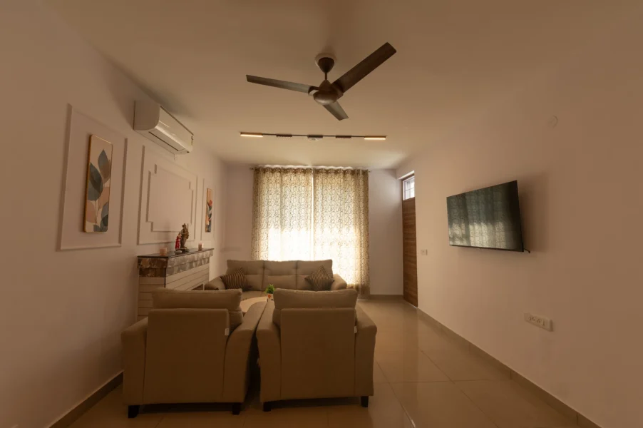 Spacious modern villa living room in Jharipani, Mussoorie featuring elegant interiors, comfortable seating, and a relaxing mountain retreat ambiance. Modern luxury villa living room with comfortable seating in Jharipani, Mussoorie, Uttarakhand.