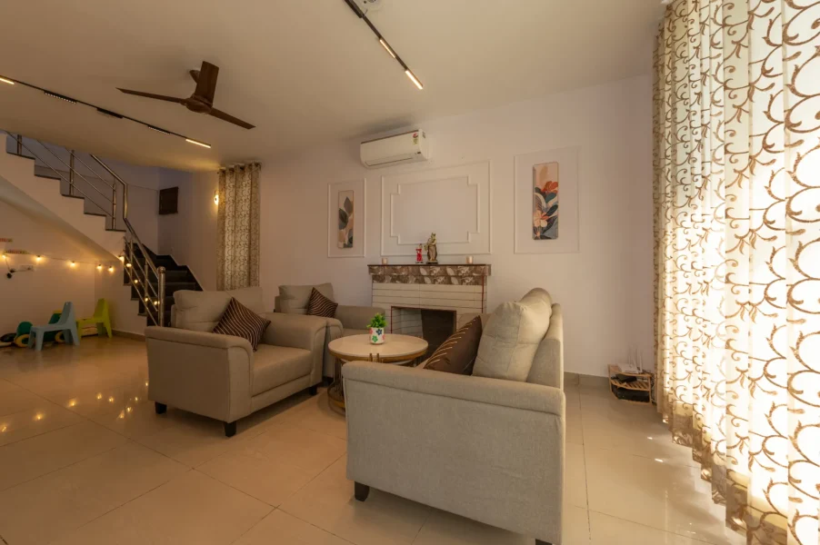 Bright and spacious holiday home living room in Mussoorie featuring modern interiors, comfortable seating, and a relaxing mountain retreat atmosphere. Spacious luxury holiday home living room with modern seating in Mussoorie, Uttarakhand.