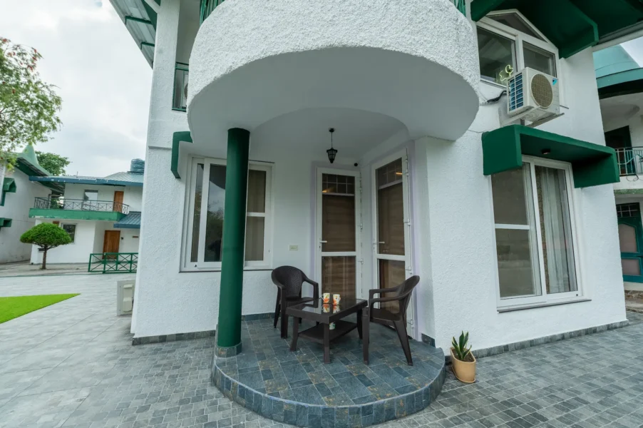 Elegant villa entrance in Barlow Ganj, Mussoorie featuring a covered porch, outdoor seating, and peaceful mountain surroundings. Private villa entrance with covered porch and outdoor seating in Barlow Ganj, Mussoorie, Uttarakhand.